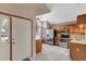 Kitchen featuring stainless steel appliances, tile flooring, granite countertops, and natural wood cabinets at 1808 Sawhorse Ct, Lutz, FL 33559