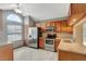 Bright kitchen with stainless steel appliances, granite countertops, and natural wood cabinetry at 1808 Sawhorse Ct, Lutz, FL 33559