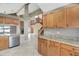 Kitchen featuring natural wood cabinets, stainless steel appliances, and an open concept design at 1808 Sawhorse Ct, Lutz, FL 33559