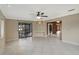 Spacious living room with tile flooring, ceiling fan and access to outdoor patio at 1808 Sawhorse Ct, Lutz, FL 33559