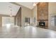 Open living area with a stone fireplace, tile floors, and seamless flow to the outdoors at 1808 Sawhorse Ct, Lutz, FL 33559