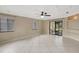 Large living room with tile flooring, neutral walls, and access to the screened patio at 1808 Sawhorse Ct, Lutz, FL 33559