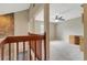 Upstairs loft with carpet and a railing overlooking the foyer. Desk and wall cabinets for convenience at 1808 Sawhorse Ct, Lutz, FL 33559