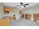 Second floor loft area featuring a ceiling fan and a built-in desk with lots of natural light at 1808 Sawhorse Ct, Lutz, FL 33559