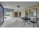 Covered patio with outdoor seating, providing a transition to screened-in pool area and a bright outdoor living space at 1808 Sawhorse Ct, Lutz, FL 33559