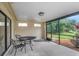 Inviting screened patio featuring a table and chairs, perfect for outdoor relaxation at 1808 Sawhorse Ct, Lutz, FL 33559
