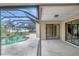 Exterior showing a private pool area with a screened enclosure and comfortable patio space at 1808 Sawhorse Ct, Lutz, FL 33559