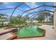 Outdoor pool area with a screened enclosure, a spa, and a spacious surrounding deck at 1808 Sawhorse Ct, Lutz, FL 33559