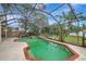 Screened-in pool area features a spa and ample patio space for outdoor entertaining and relaxation at 1808 Sawhorse Ct, Lutz, FL 33559