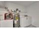 Utility room featuring a washer, dryer, and water heater offering convenience at 1808 Sawhorse Ct, Lutz, FL 33559