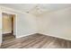 Bright bedroom features modern wood-look floors, neutral walls, and a ceiling fan at 18533 Bridle Club Dr # 18533, Tampa, FL 33647