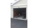 Spacious single-car garage with an open door and ample storage space, providing convenience and security at 18533 Bridle Club Dr # 18533, Tampa, FL 33647