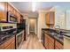 Kitchen with granite countertops, stainless steel appliances, and wood-look flooring at 18533 Bridle Club Dr # 18533, Tampa, FL 33647