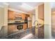 Kitchen featuring granite countertops, stainless steel appliances, and wood cabinets at 18533 Bridle Club Dr # 18533, Tampa, FL 33647