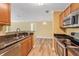 Kitchen with stainless steel appliances, granite countertops, and wood cabinets at 18533 Bridle Club Dr # 18533, Tampa, FL 33647