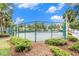 Exterior view of the tennis courts surrounded by mature landscaping on a sunny day at 18533 Bridle Club Dr # 18533, Tampa, FL 33647