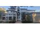 Stately two-story home featuring a grand entrance, manicured landscaping, and decorative palm trees at 1931 Oak Ridge Ct, Clearwater, FL 33759