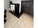 A modern fireplace with dark cabinets on a tiled floor at 1931 Oak Ridge Ct, Clearwater, FL 33759