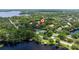 Waterfront property featuring lush trees and a serene lake view at 1936 Floresta View Dr, Tampa, FL 33618