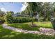 An outdoor living space with beautiful landscaping and a screened in pool at 1936 Floresta View Dr, Tampa, FL 33618