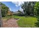 The backyard features lush green grass and attractive landscaping at 1936 Floresta View Dr, Tampa, FL 33618