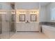 Elegant main bathroom with double vanities, a glass-enclosed shower, and a soaking tub at 1936 Floresta View Dr, Tampa, FL 33618