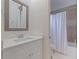 A bright bathroom boasts a vanity with white countertops, a shower and a toilet at 1936 Floresta View Dr, Tampa, FL 33618