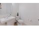 This half-bathroom features a pedestal sink, toilet and fresh paint throughout at 1936 Floresta View Dr, Tampa, FL 33618