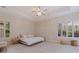 Bright and airy bedroom featuring plantation shutters and trey ceiling at 1936 Floresta View Dr, Tampa, FL 33618