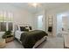 Inviting bedroom featuring a neutral color scheme, a window with shutters and an ensuite bathroom at 1936 Floresta View Dr, Tampa, FL 33618
