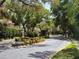 Elegant gated entrance with lush landscaping and a water fountain feature at 1936 Floresta View Dr, Tampa, FL 33618