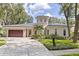 Stunning home with a turret entrance, lush landscaping, and a spacious two-car garage at 1936 Floresta View Dr, Tampa, FL 33618