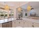 Open kitchen with island, bar seating and decorative pendant lights at 1936 Floresta View Dr, Tampa, FL 33618