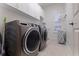 Laundry room with new washer and dryer and storage cabinets at 1936 Floresta View Dr, Tampa, FL 33618