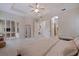 Spacious main bedroom with tray ceilings, white trim, and an ensuite bathroom at 1936 Floresta View Dr, Tampa, FL 33618