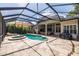 A covered outdoor pool, patio, and hot tub provide plenty of space for entertaining at 1936 Floresta View Dr, Tampa, FL 33618