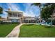 A spacious lawn with a pool, deck, and patio with chairs at 1988 Carolina Ne Cir, St Petersburg, FL 33703