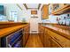 Stylish bar area features wood cabinetry, a beverage cooler, a sink, and plenty of storage space at 1988 Carolina Ne Cir, St Petersburg, FL 33703
