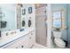 Bright bathroom with a window, a toilet, a shower, and a white vanity at 1988 Carolina Ne Cir, St Petersburg, FL 33703