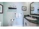 Elegant bathroom features a vanity with granite countertop, decorative mirror, and stylish fixtures at 1988 Carolina Ne Cir, St Petersburg, FL 33703