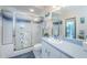 Bright bathroom with a shower, white tile, and blue vanity, offering both style and functionality at 1988 Carolina Ne Cir, St Petersburg, FL 33703