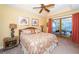 Cozy bedroom with a king-size bed, ceiling fan, and sliding glass doors to a screened patio overlooking the water at 1988 Carolina Ne Cir, St Petersburg, FL 33703