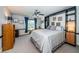 Bedroom with a bed featuring blue accents, a gray carpet, and a window with a view at 1988 Carolina Ne Cir, St Petersburg, FL 33703
