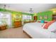 Bright bedroom with green walls, multiple windows, a ceiling fan, and classic furnishings at 1988 Carolina Ne Cir, St Petersburg, FL 33703