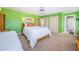 A bedroom showcasing two beds, bright green walls, and white trim work at 1988 Carolina Ne Cir, St Petersburg, FL 33703