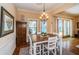Dining area with wood floors and a view of the lanai with a pool beyond at 1988 Carolina Ne Cir, St Petersburg, FL 33703