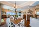 Open dining area with wood floors and views into the living room and kitchen at 1988 Carolina Ne Cir, St Petersburg, FL 33703