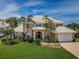 Beautiful two-story home with lush landscaping, tile roof, and a brick driveway at 1988 Carolina Ne Cir, St Petersburg, FL 33703