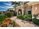 Paver walkway leads to a welcoming entrance surrounded by lush tropical landscaping at 1988 Carolina Ne Cir, St Petersburg, FL 33703