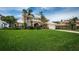 Two-story home with manicured lawn and mature landscaping and a two car garage at 1988 Carolina Ne Cir, St Petersburg, FL 33703